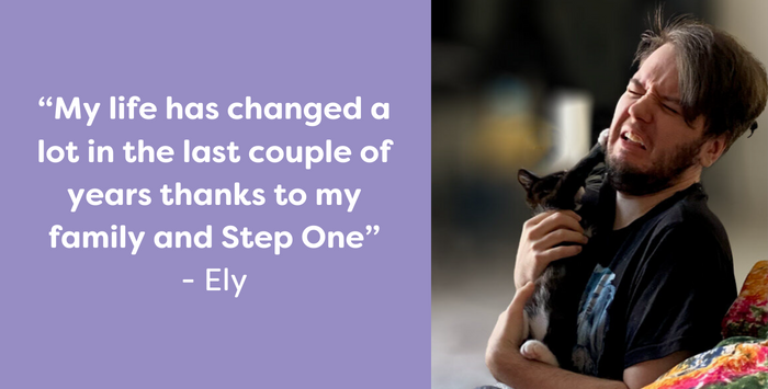 Ely, a Step One Charity service user, playing with pet cat