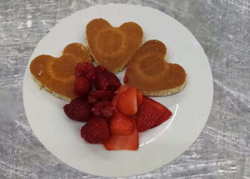 A plate of heart-shaped pancakes and fruit at Cypress