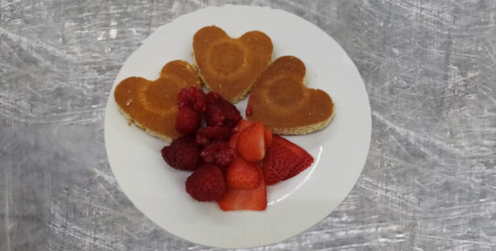 A plate of heart-shaped pancakes and fruit at Cypress