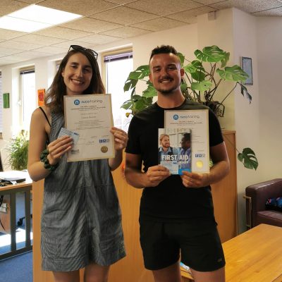 Two people holding certificates
