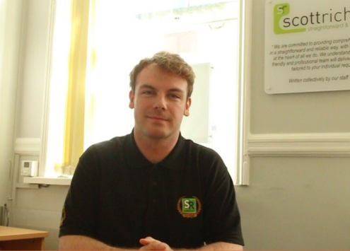 Solicitor in an office smiling towards the camera