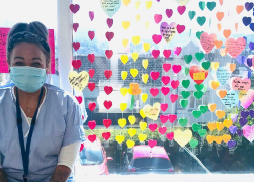 Step One Charity staff member at Cypress Hospital showcasing a colorful craft display for Mental Health Awareness Week, celebrating kindness.