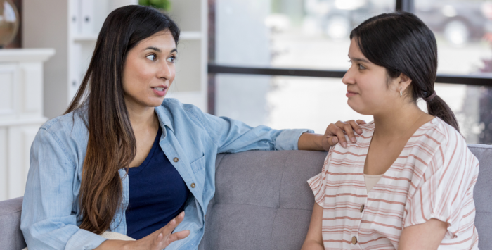 Two women talking on the sofa