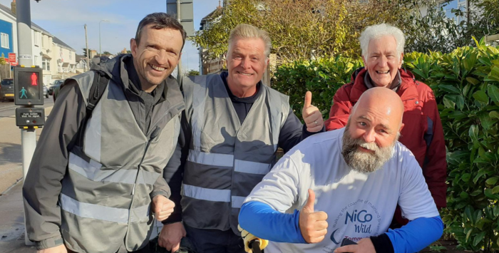 4 men smiling on a walk